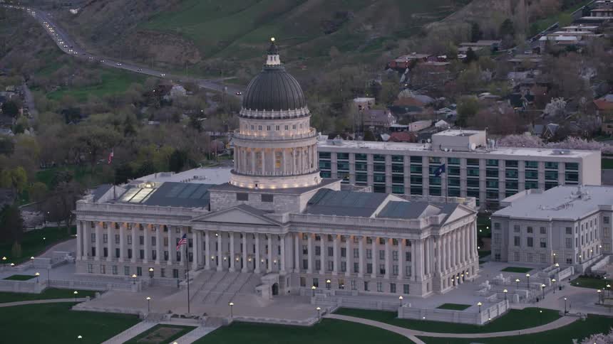 Aerial view of a capitol building near the hills on a small town at evening