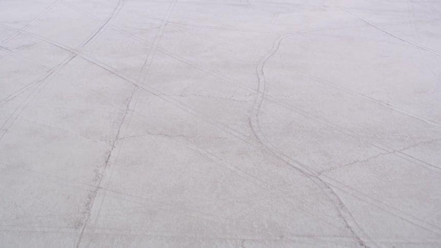 Pull marks mar the surface of a snow covered field