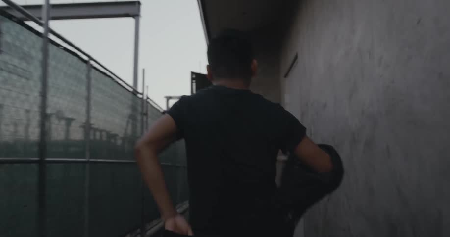 A man takes off his jacket as he walks to the security door of his job