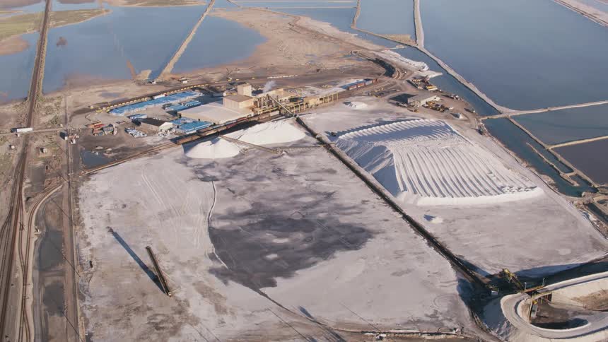 Aerial view of piles of salt on a salt plant factory in a deserted area