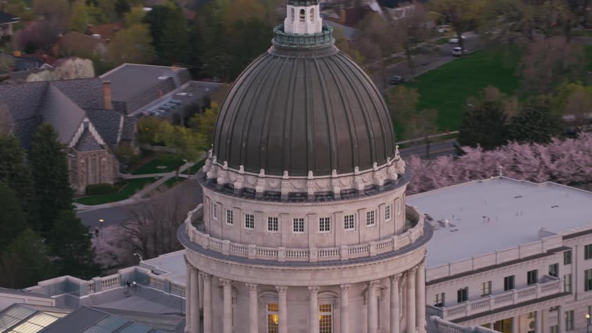 Aerial view of the dome of a capitol building on a small town at evening