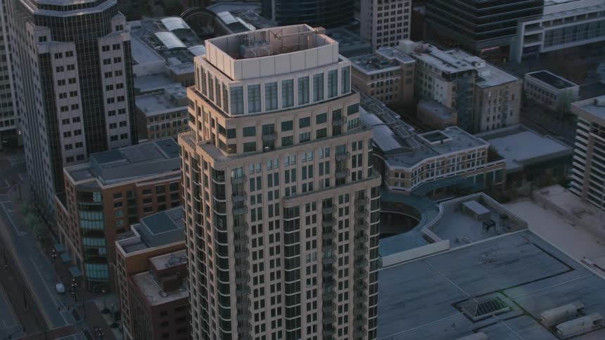 Aerial view of a downtown city is displayed with tall sky scrapers
