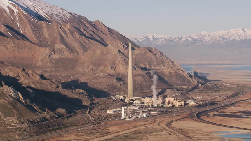 A power plant is near a mountain range