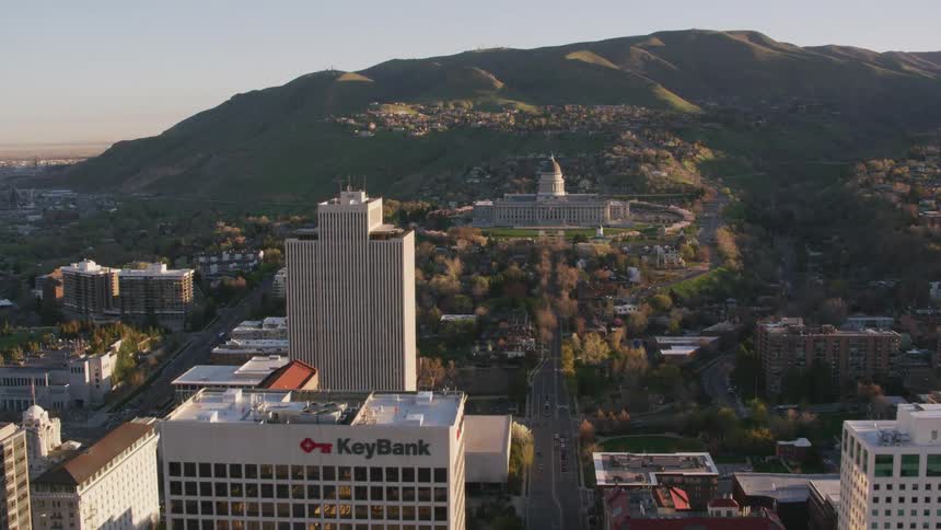 An aerial view of office buildings in a city in front of a large government building