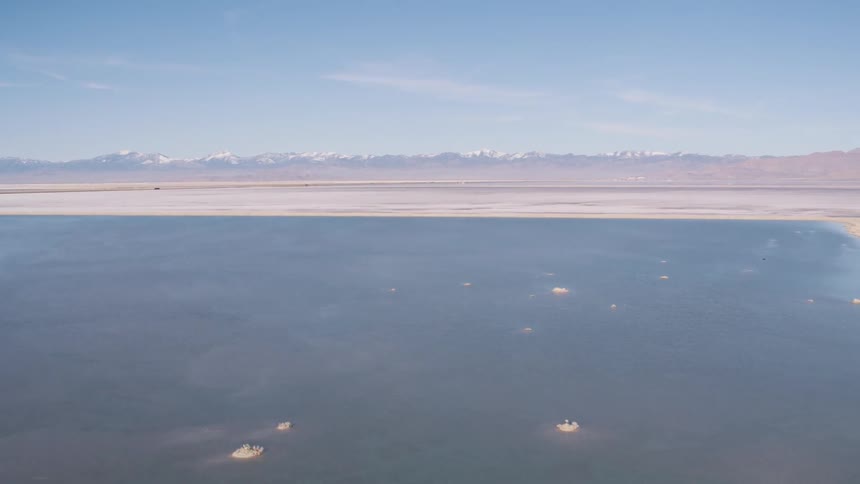 A river runs along a lake in the desert