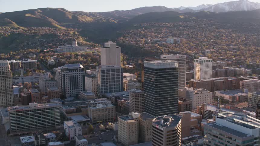 A downtown city sits near a mountain range