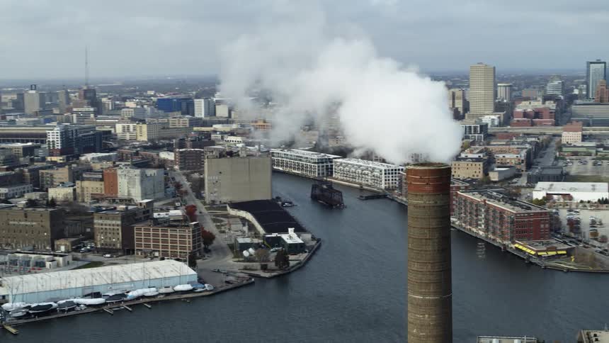 Haze covers city as light traffic crosses bridge over water