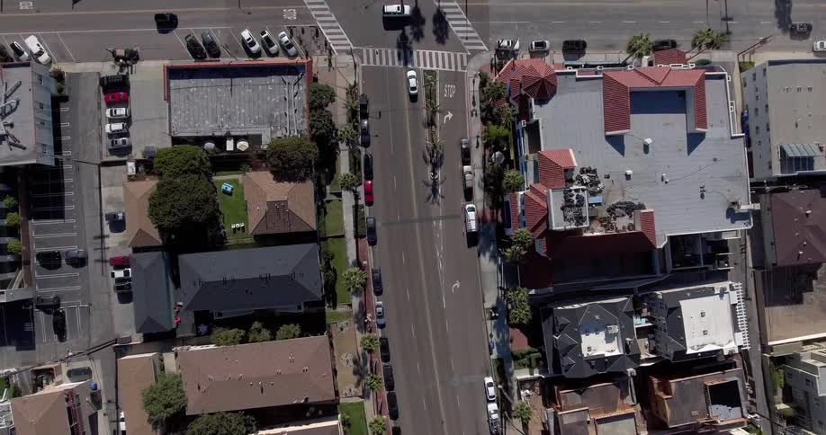 Aerial view of a town with cars and people traveling below