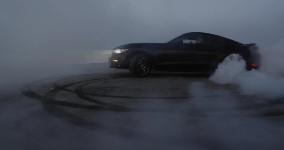 A car is doing doughnuts on the field