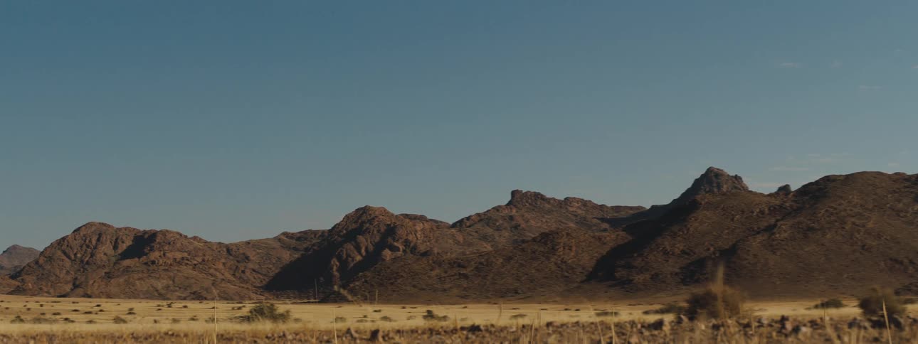 Mountain range in the desert with clear blue skies