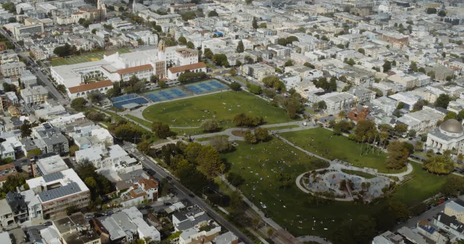A stadium and park sit in the middle of a neighborhood and suburban businesses