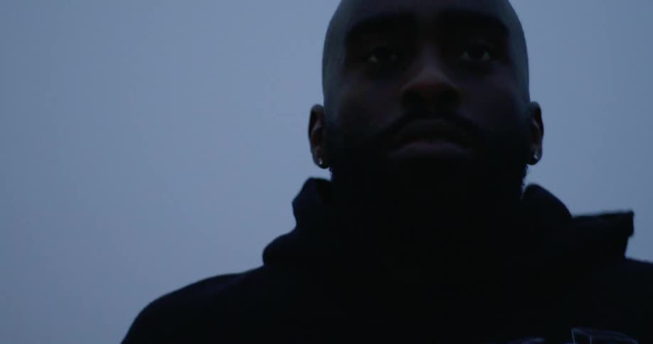 Silhouette of a man wearing a hoodie jogging in the early hours of the morning