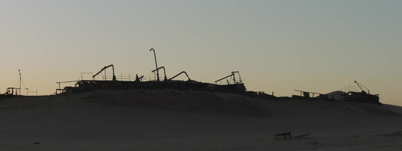 The silhouette of the Eduard Bohlen shipwreck covered in sand