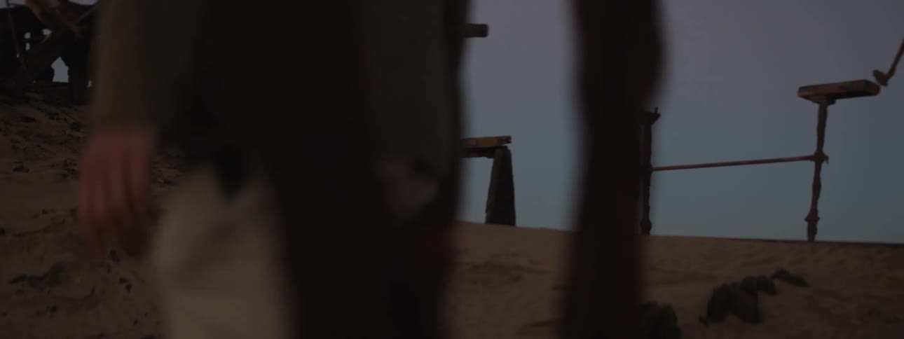 A man walks by rusted remains on shipwreck