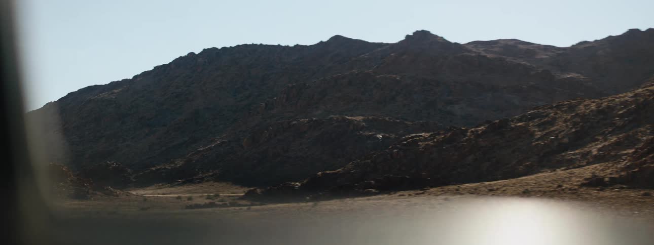 Mountains in the desert from a moving vehicle