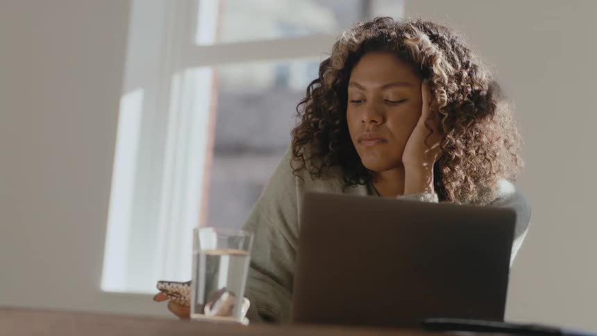 A tired woman working in the office