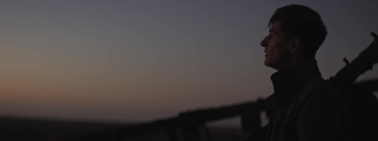 Young man checks his watch in the desrt at dusk