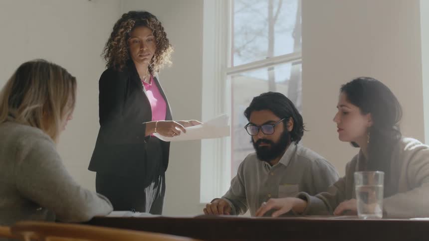 A diverse group of young coworkers collaborate during a business meeting