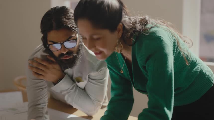 Coworkers discussing floor plans