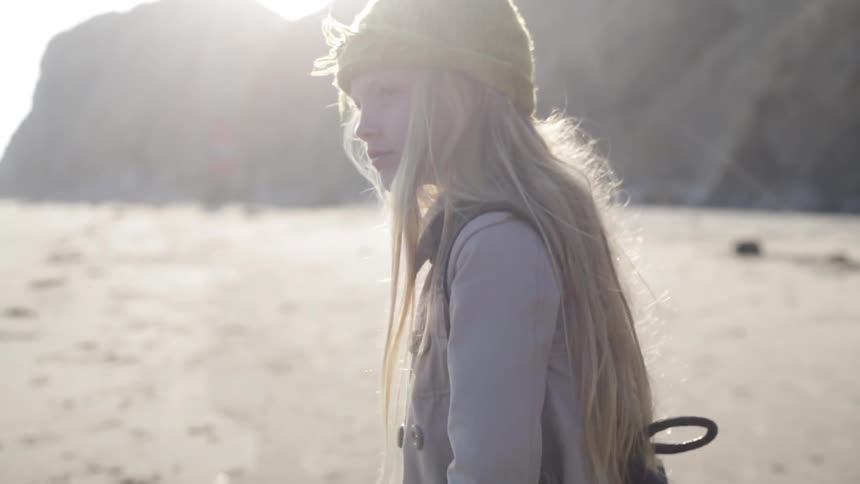 A girl throws a rock and walks away