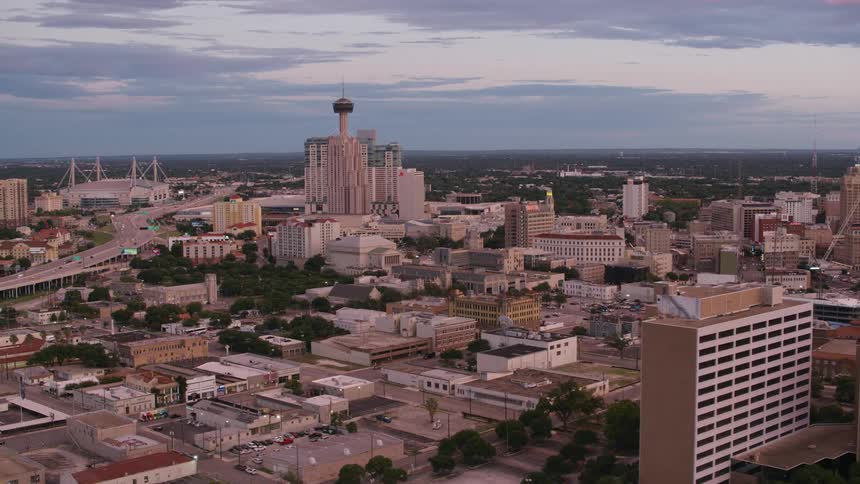 The san antonio city skyline and downtown with traffic on a main highway