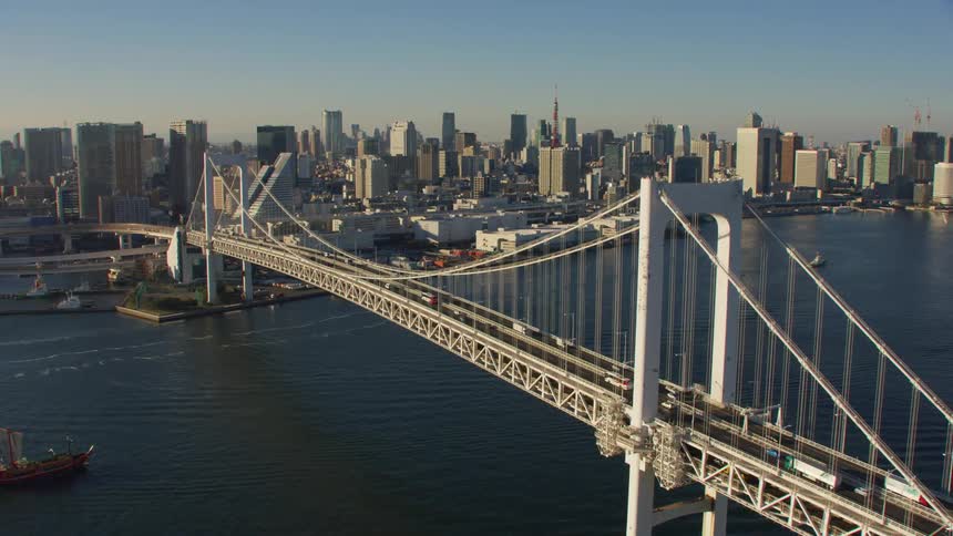 Aerial view of cars driving on a bridge over a body of water