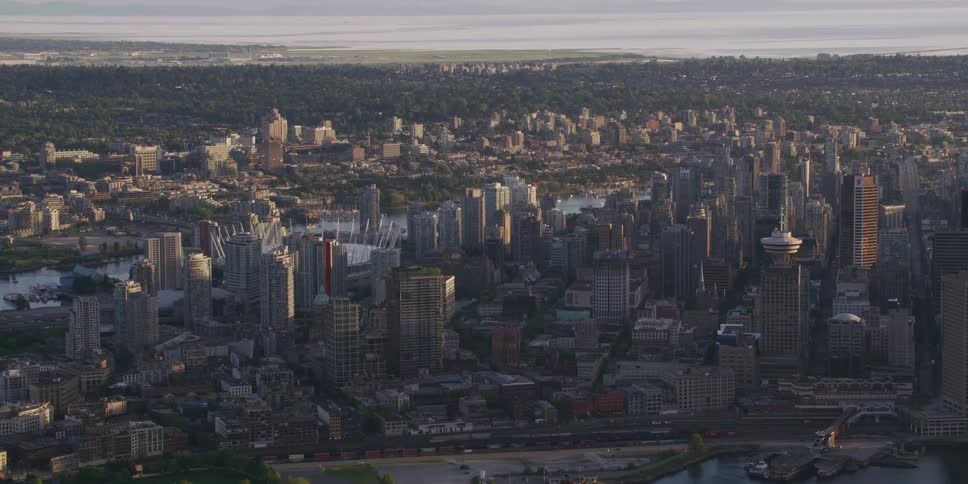 Tall buildings and skyscrapers along a waterway in a metropolis during the day