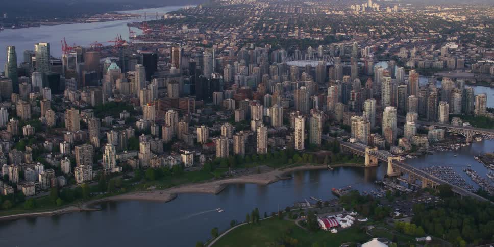 A dense metropolis along a waterway during the day