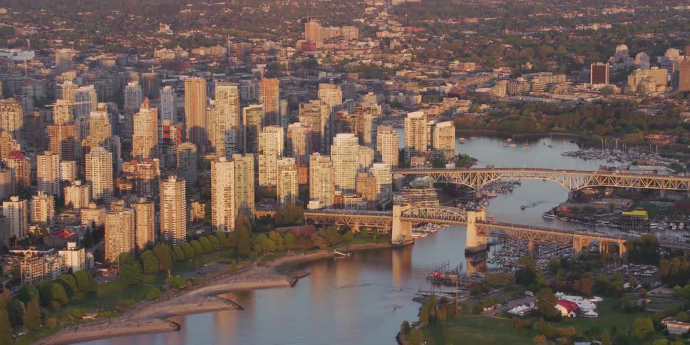Aerial view of a downtown city near the river is displayed