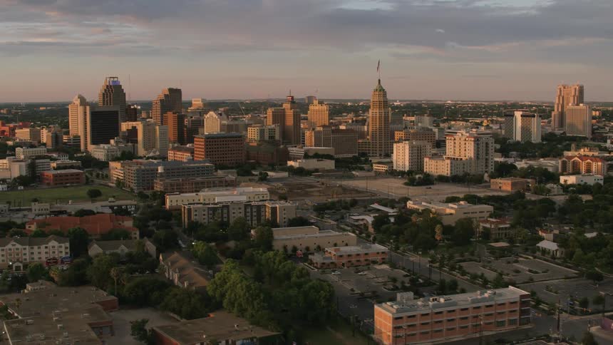 Aerial view of office buildings and apartment buildings in the city at dusk