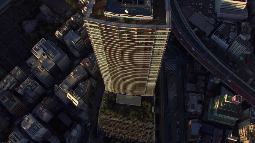 Vehicles travel past the tall buildings
