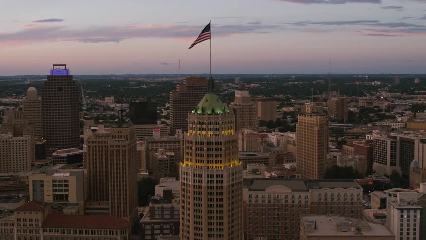 American flag sits on flagpole on top of building in downtown