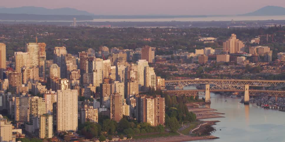 Aerial view of a downtown city at dusk is displayed
