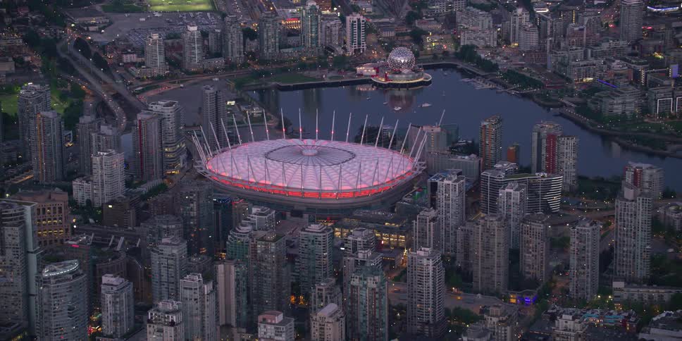 A stadium in the heart of a coastal city is lit up at night