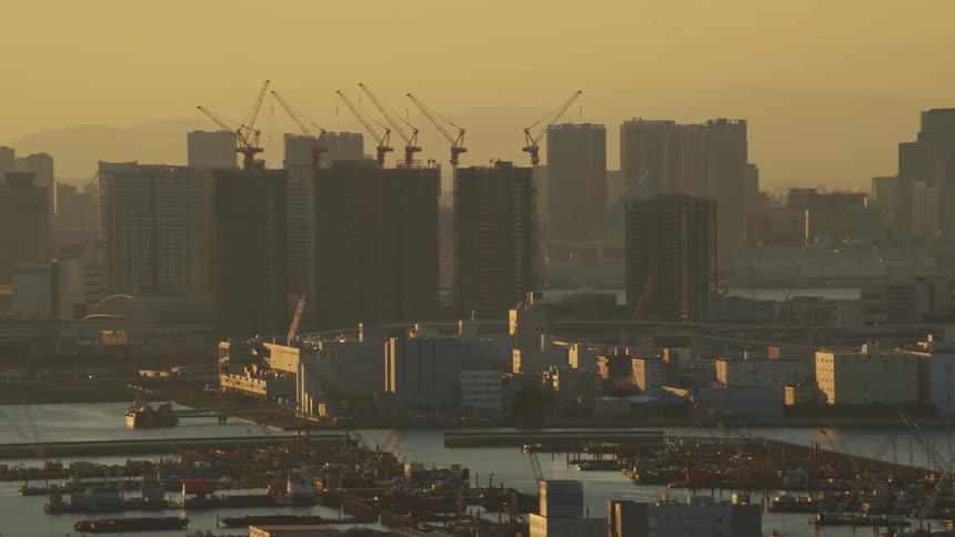 Aerial view of a downtown city during sunset is displayed