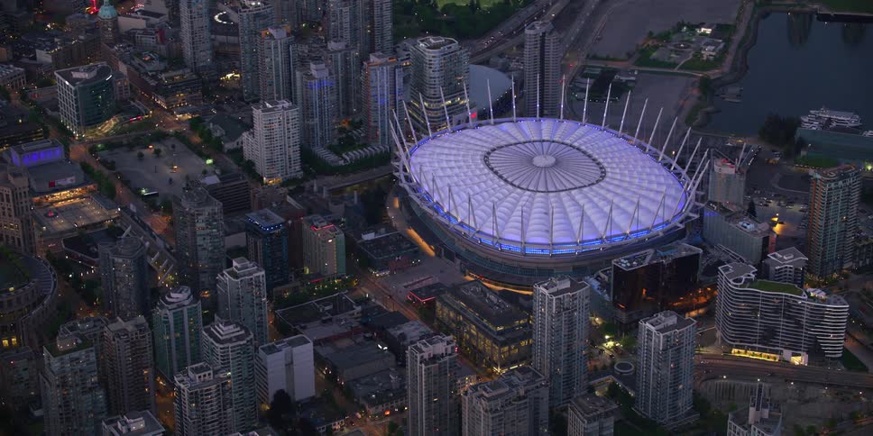 The stadium is lit in the city