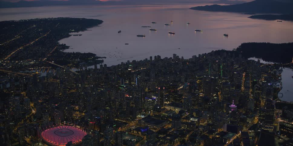 Aerial view of a skyline at dusk is displayed