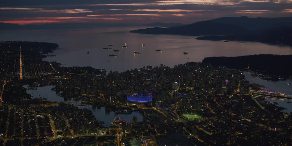 Aerial view of a downtown city near a coast is displayed