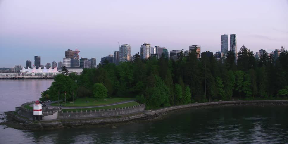 An aerial view of a river in front of a city skyline