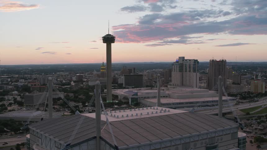 An aerial flyover of a metropolitan area reveals many remarkable buildings near a large freeway