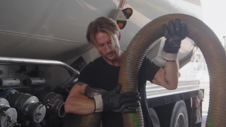 A man fills gas from his truck in the station