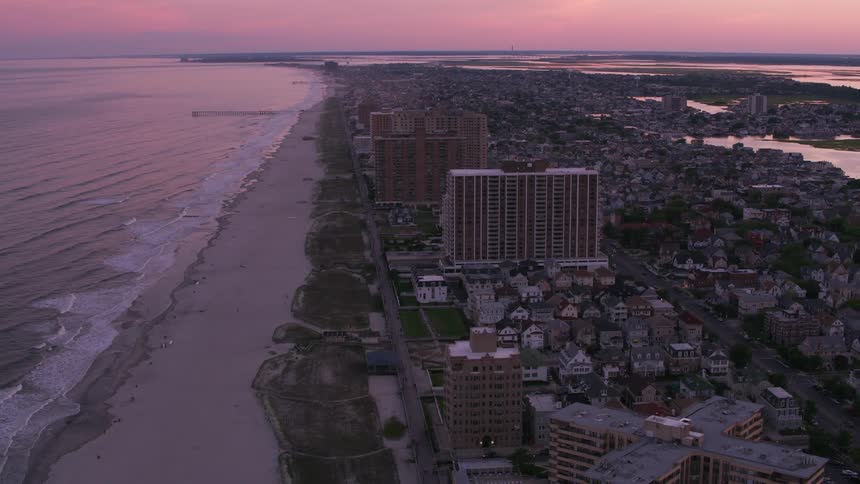 Buildings and houses in a coastal city at sunrise