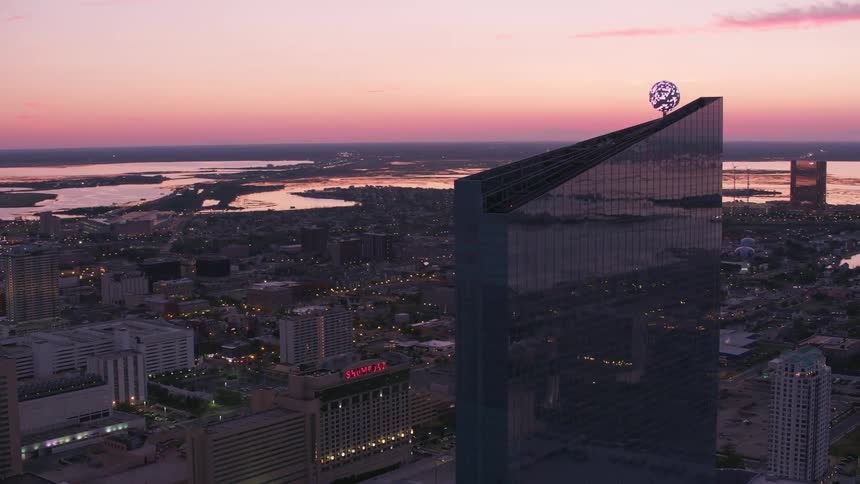 Aerial view of a downtown city during dusk is displayed