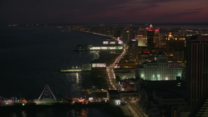 Aerial view of a downtown city is displayed at night