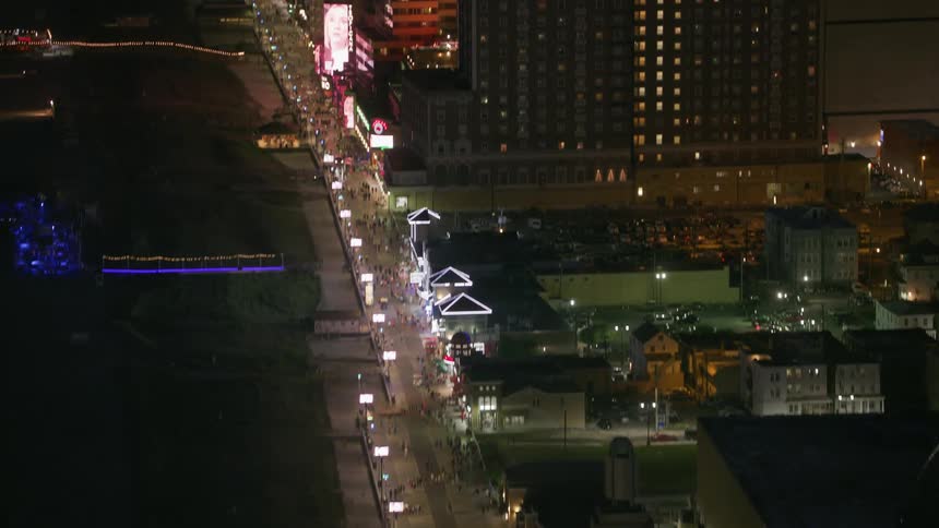People are walking down the road by the city