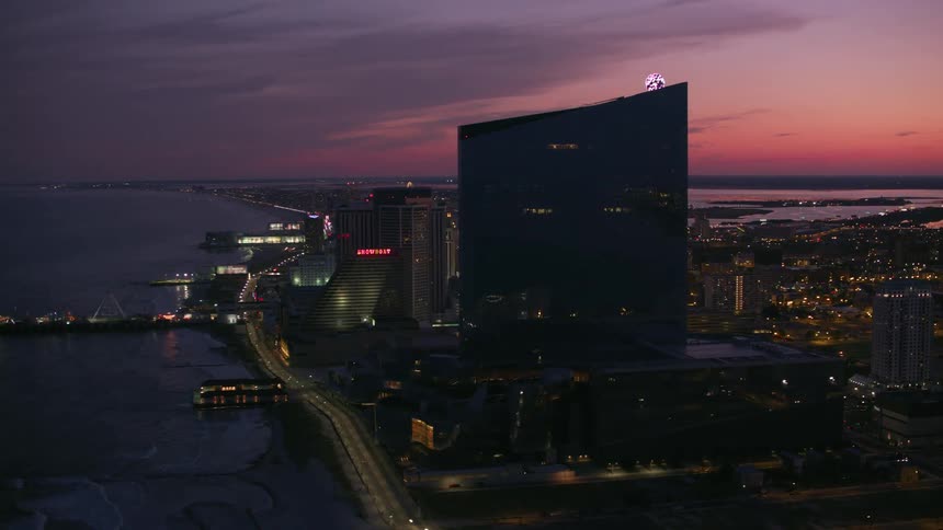 Aerial view of a downtown city at dusk is displayed