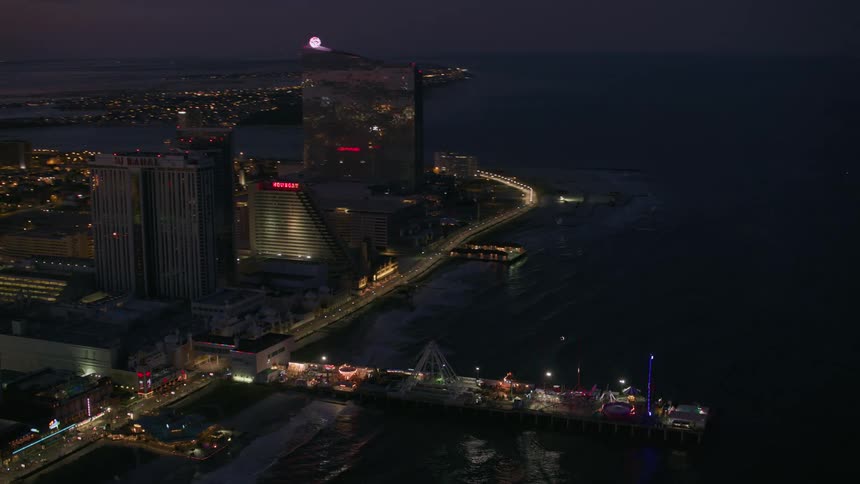 The atlantic city skyline and pier shimmering and flashing with lights at dusk
