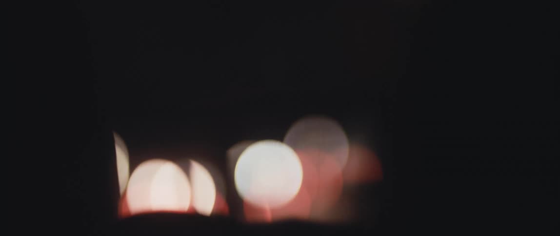 Out of focus lights soon from a moving vehicle at night