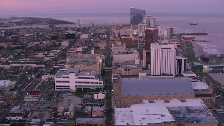 Tall buildings in a metropolis on the coast in the evening