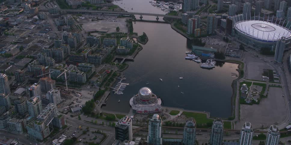 An elaborately designed building on the shore of an inlet in metropolis during the day